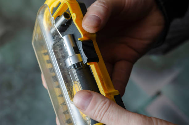 istock A man is holding a yellow and black box of screwdriver bits. 1317374941