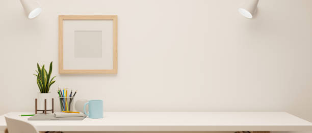 istock 3D rendering, minimal working space with stationery and decorations on white table and mock-up frame on the wall 1317375561
