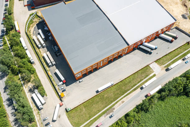 istock cargo trucks in industrial warehouse or logistic center waiting for loading goods. aerial photography with drone 1317376588