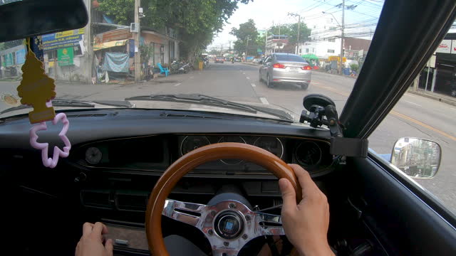 POV Shot Driving in a classic car on bangkok road.