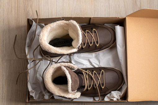new brown leather insulated winter boots with membrane and fur. in the box top view