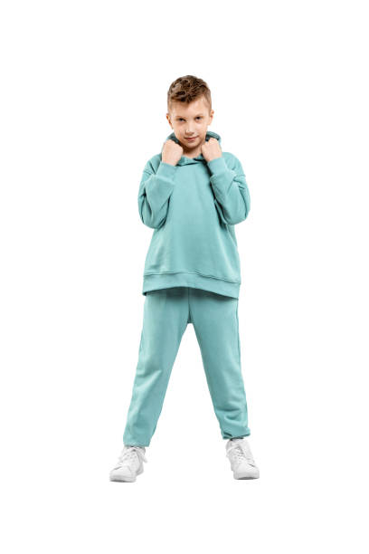 istock boy in turquoise blue tracksuit isolated on white background. 1317378567
