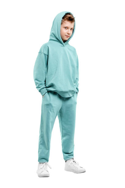 istock boy in turquoise blue tracksuit isolated on white background. 1317378568