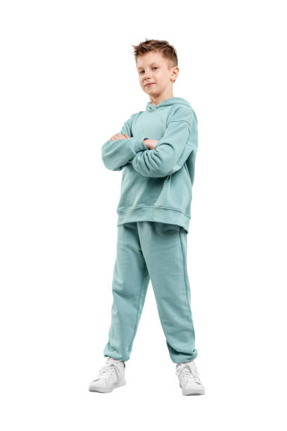 istock boy in turquoise blue tracksuit isolated on white background. 1317378571