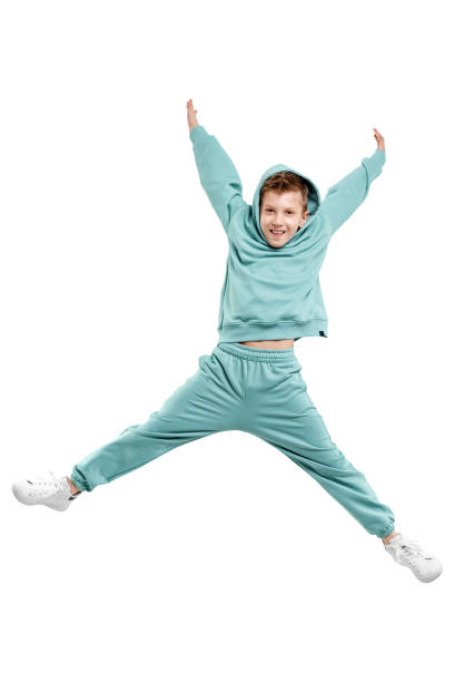 istock boy in turquoise blue tracksuit isolated on white background. 1317378573