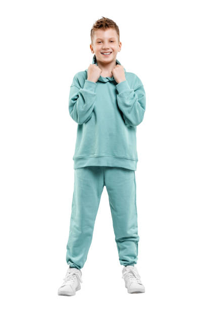 istock boy in turquoise blue tracksuit isolated on white background. 1317378574