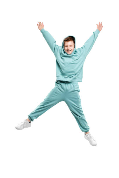 istock boy in turquoise blue tracksuit isolated on white background. 1317378581