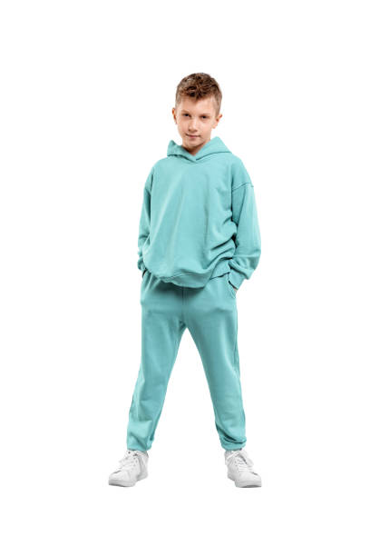 istock boy in turquoise blue tracksuit isolated on white background. 1317378585