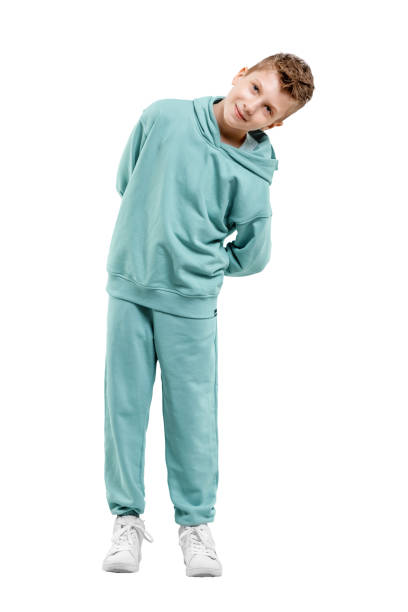 istock boy in turquoise blue tracksuit isolated on white background. 1317378586