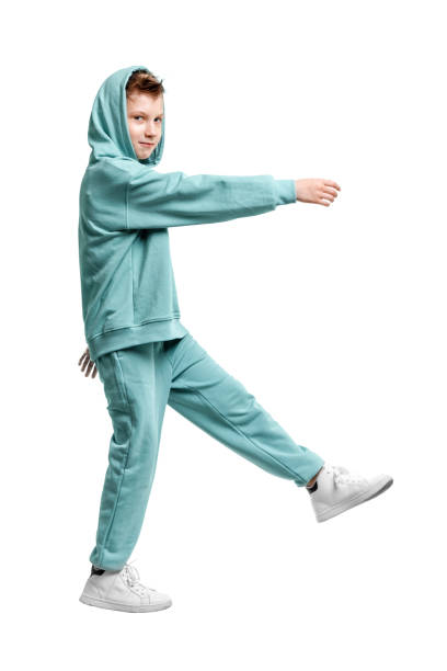 istock boy in turquoise blue tracksuit isolated on white background. 1317378594