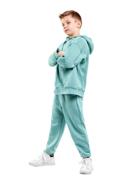 istock boy in turquoise blue tracksuit isolated on white background. 1317378599