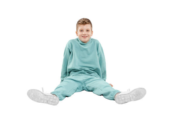 istock boy in turquoise blue tracksuit isolated on white background. 1317378602