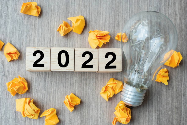 istock 2022 text wood cube blocks and crumbled paper with lightbulb on wooden table background. New Year New Ideas, Creative, Innovation, Imagination, inspiration, Resolution, Strategy and goal concept 1317379366