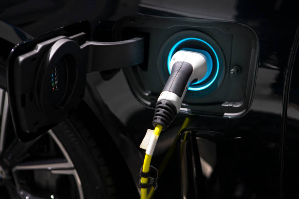 Charging cable plugged into the side of electric car, Car or Electric vehicle, Eco-friendly sustainable energy concept. stock photo
