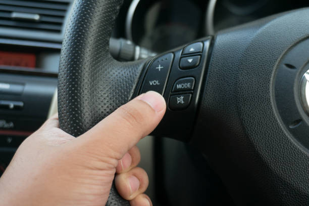 istock Man driving hands pushing button on the steering wheel in the car selective focus. safety driving concept 1317380525