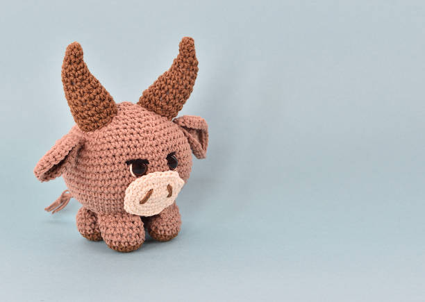 istock Brown bull knitted from thick cotton yarn 1317381374