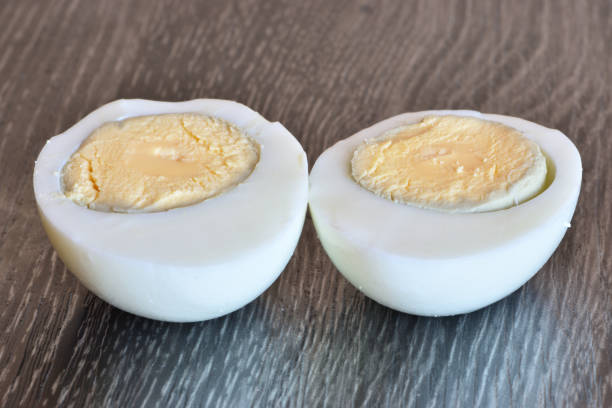 istock Two halves of boiled chicken egg on a cutting board 1317381467