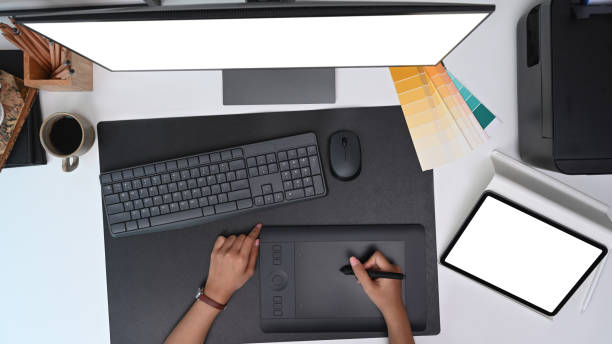 istock Hight angle view of graphic designer working with graphic tablet at creative workspace. 1317382294