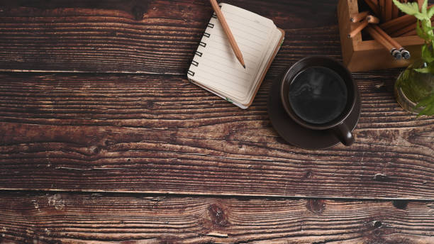 istock Empty notebook, coffee cup, pencil holder and plant on wooed desk. 1317382313