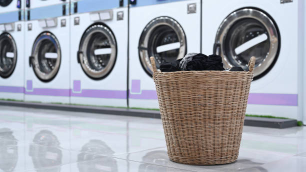 istock A basket of laundry and public laundromat. 1317382333
