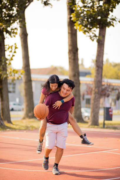 istock Young happy  couple playing basketball. 1317382469