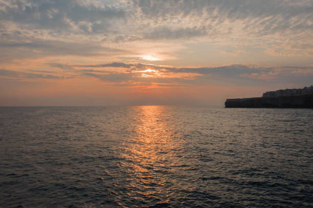 istock Sunrise in the clouds. Golden path on sea water 1317383347