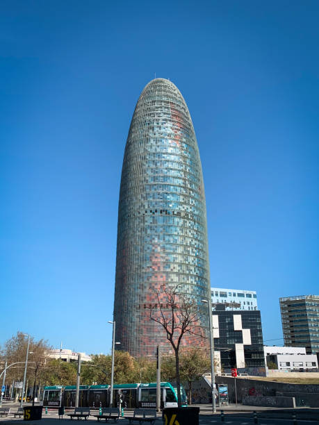 Barcelona, Spain - March 11, 2020: The tower skyscraper Torre Agbar. View from El Parc i la Llacuna del Poblenou.