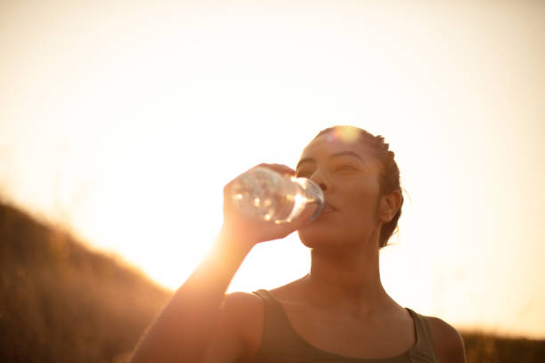 istock Sporty young woman drinking water outdoors. Time for refresh. 1317384553