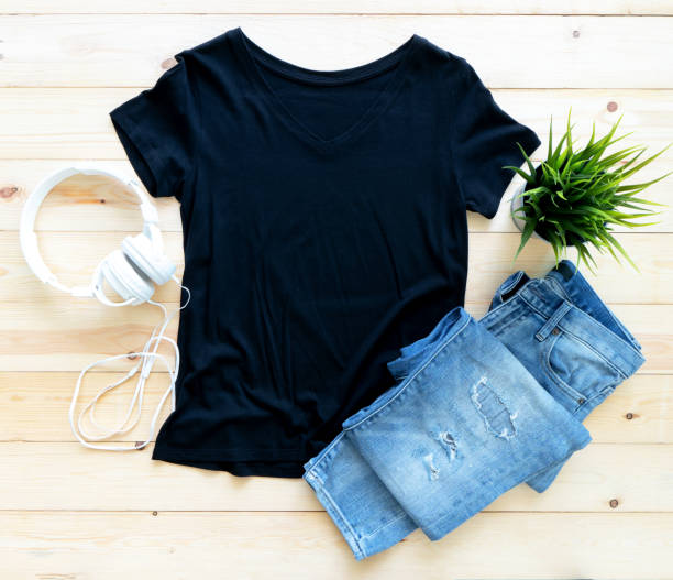 istock Black tshirt mockup and short jeans on brown wooden background. Template, flat lay, template 1317385895