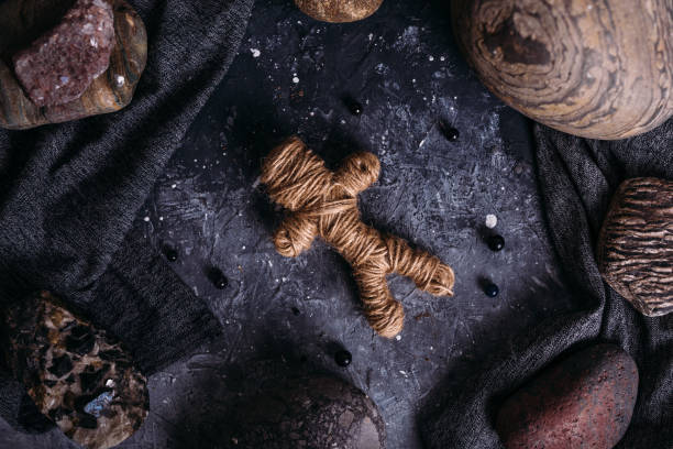 istock Voodoo doll woven of thread on the witch's table. 1317387069