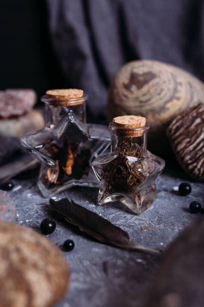 istock Glass bottles are filled with magical ingredients. Witch's table, stones. 1317387579