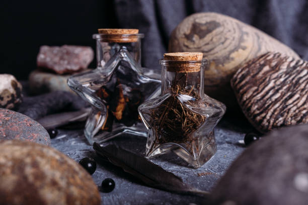 istock Glass bottles are filled with magical ingredients. Witch's table, stones. 1317387585