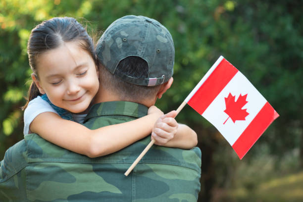 istock Canadian Soldier And His Daughter 1317387876