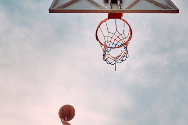 istock Hand throws basketball to the hoop 1317388752