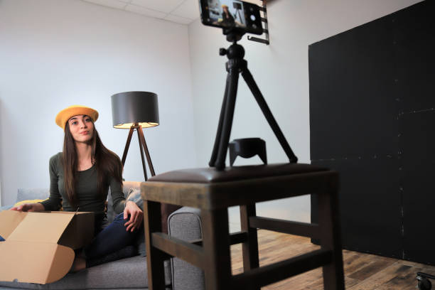 istock Young woman vlogging from home 1317390011