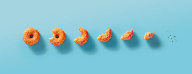Eaten donut stages, blue background, top view