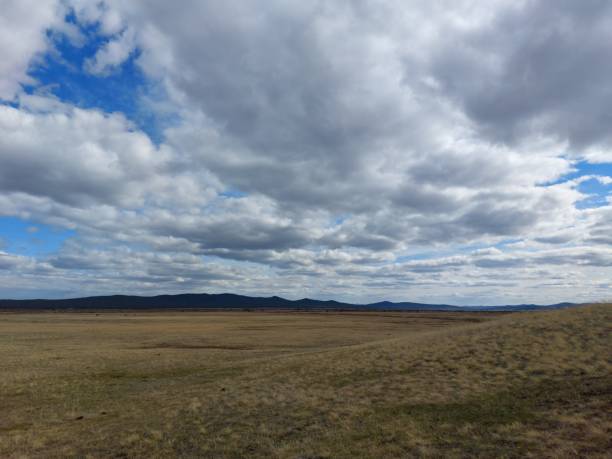 istock Spring valley view and mountains on horizon under Blue Sky and white fluffy clouds 1317390690