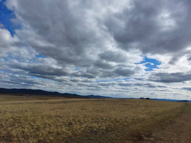 istock Spring valley view and mountains on horizon under Blue Sky and white fluffy clouds 1317390694