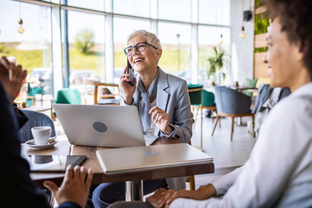istock Business woman using phone in a cafe. 1317390716