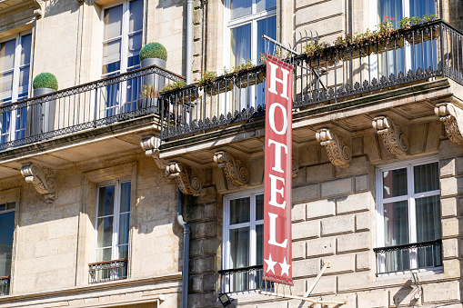 Hotel sign text and 2 stars in wall building facade in french tourist city