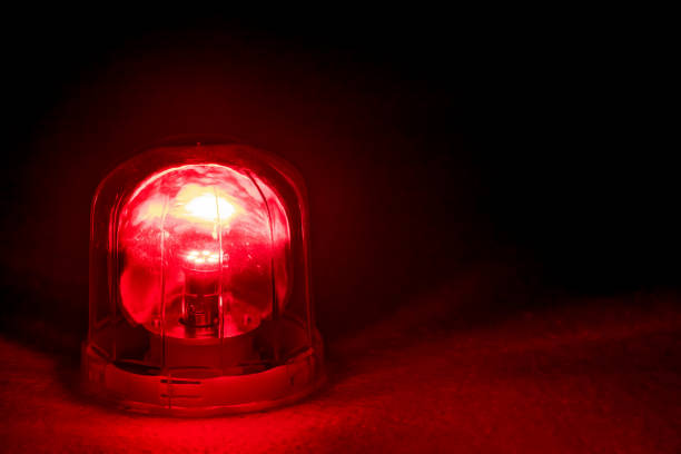 Emergency rotating alarm red light at night. stock photo