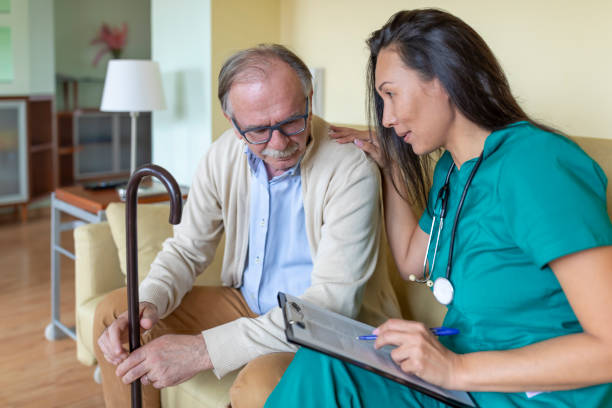 istock Sick Old Man is Receiving Advice From Nurse in Home Visit. 1317398545