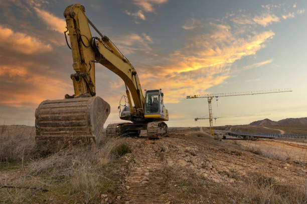 istock Excavator at the end of a working day in a construction site 1317399061