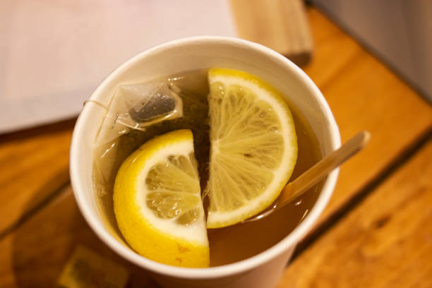 Tea with lemon slices in a plastic glass