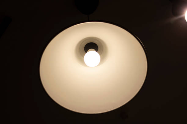 istock Round glowing lamp on the ceiling in the dark 1317401570
