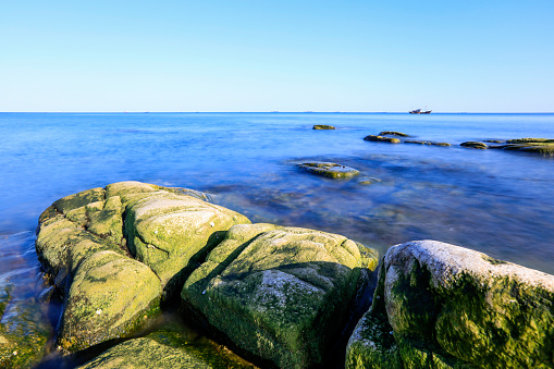 Seaside scenery, the sea under the blue sky, the rocks on the sea.