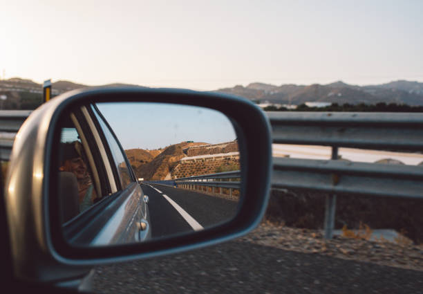 istock Close-Up Of Side-View Mirror Against Clear Sky 1317404391