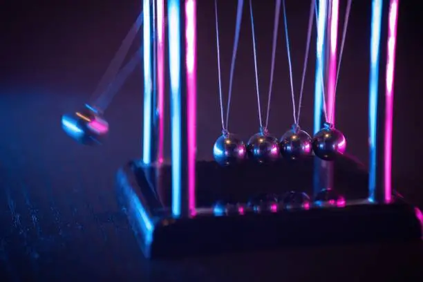 Newton cradle. Demonstrating gravity, action and reaction principle in physics.