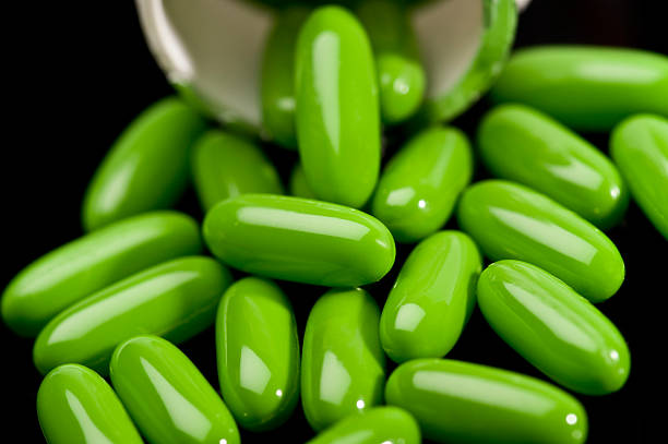 green-gel ernährung kapseln - capsule gel effect pill vitamin pill stock-fotos und bilder