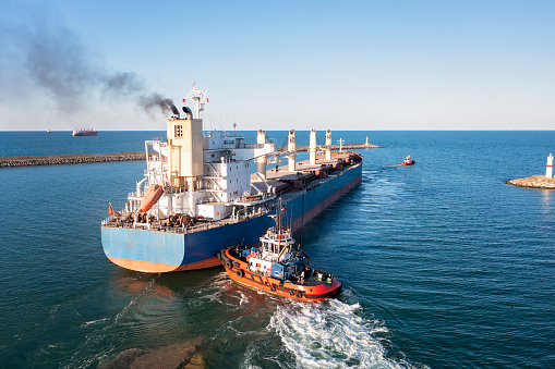 Aerial view of Large Cargo Ship Vessel leaving. Freight ship departs from port. import export logistic and export products worldwide